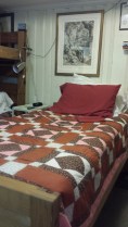 Not as comfortable as the hotel beds, but it's paid for, and the handmade quilt is cheerful.