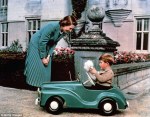 1952-Princess_Elizabeth_watches_her_son_Prince_Charles_playing_in_his-toy car